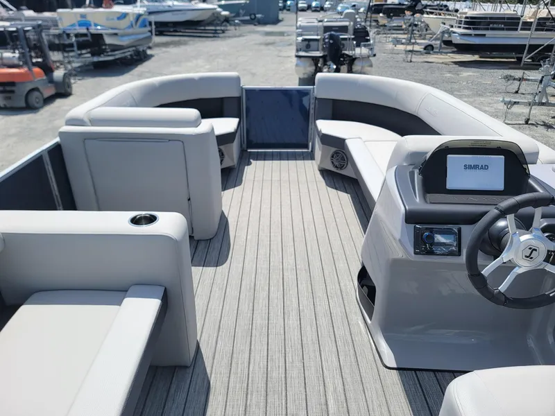 Slide: The Image of 2025 Harris Cruiser 210 pontoon boat interior with modern seating and steering console. - 31