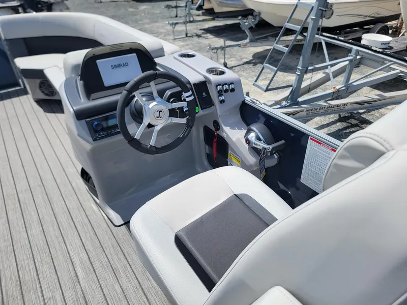 Slide: The Image of 2025 Harris Cruiser 210 boat cockpit with steering wheel and control panel. - 32