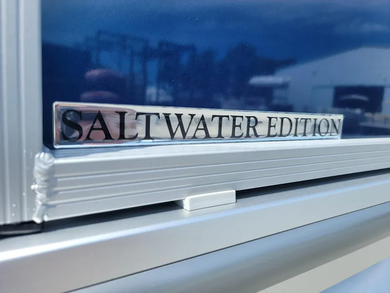 Slide: The Image of 2025 Harris Cruiser 210 Saltwater Edition emblem on boat exterior. - 38