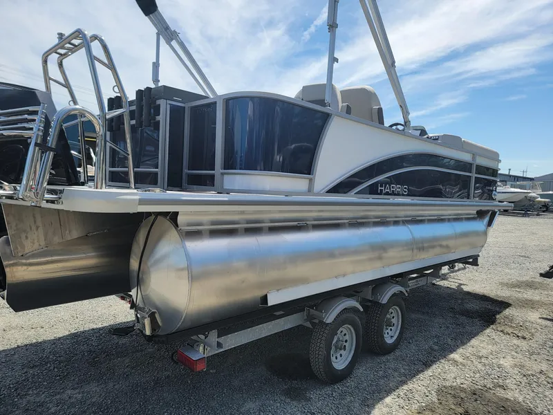 Slide: The Image of 2025 Harris Cruiser 210 pontoon boat on a trailer. - 4
