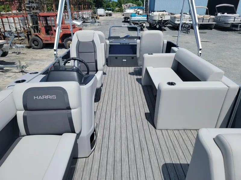 Slide: The Image of 2025 Harris Cruiser 210 pontoon boat with spacious seating and modern design. - 8
