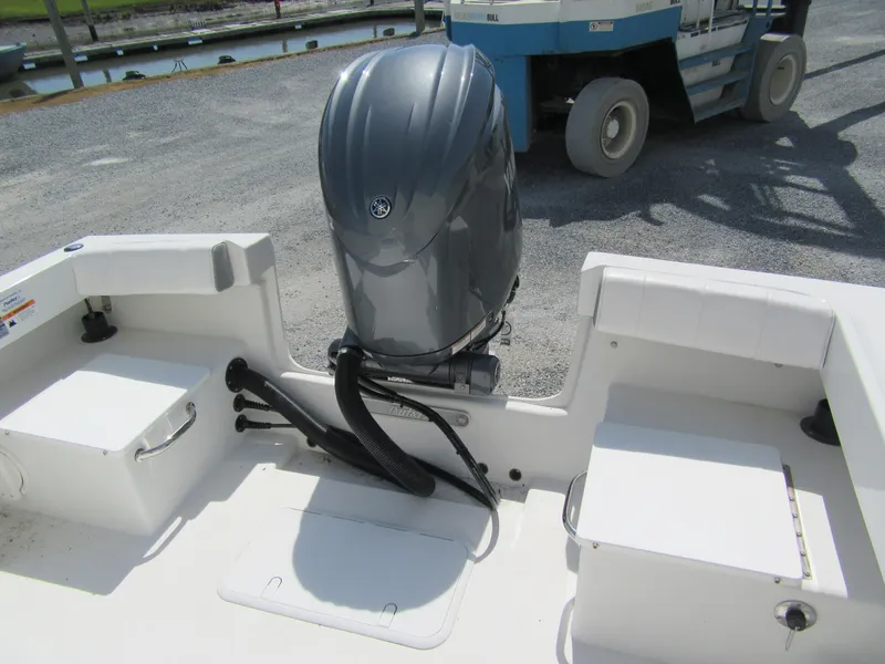 Slide: The Image of 2025 Parker 2300 SE CC boat with outboard motor at dock. - 3
