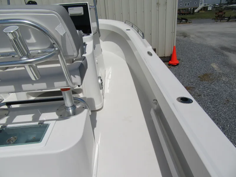 Slide: The Image of 2025 Parker 2300 SE CC boat interior, white deck, and seating area. - 9