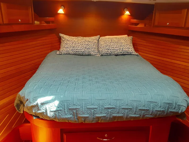 Slide: The Image of Cozy bedroom in 2016 Sabre 48 Salon Express yacht with blue bedding. - 27