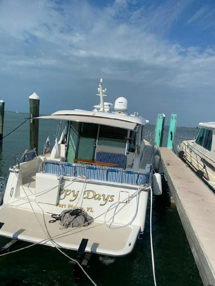 Slide: The Image of 2016 Sabre 48 Salon Express yacht docked at a marina under a clear sky. - 36