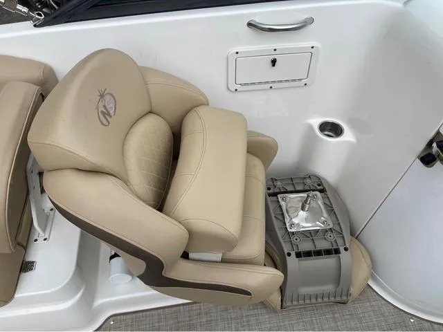 Slide: The Image of 2020 NauticStar 243 DC boat interior with beige seating and storage compartment. - 11