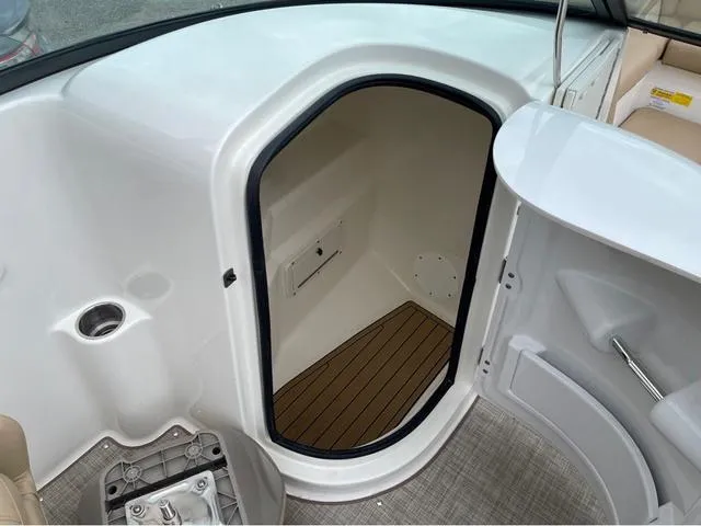 Slide: The Image of 2020 NauticStar 243 DC boat interior cabin with wooden flooring. - 13