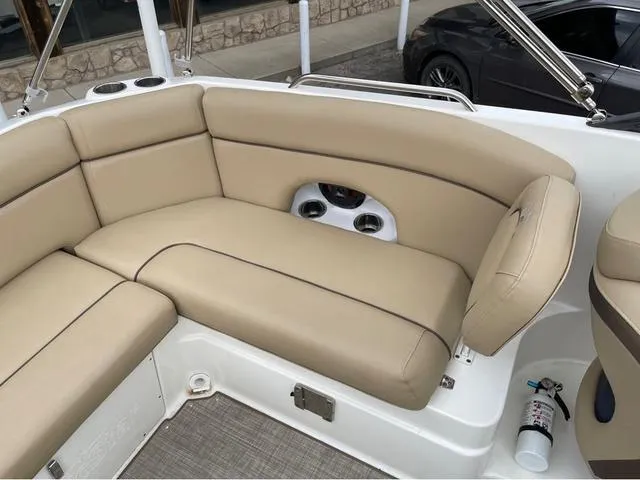 Slide: The Image of 2020 NauticStar 243 DC boat with beige cushioned seating and cup holders. - 17