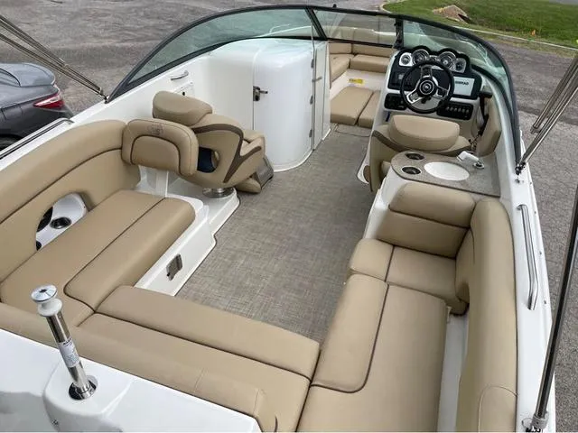 Slide: The Image of 2020 NauticStar 243 DC boat interior with beige seating and modern dashboard. - 6
