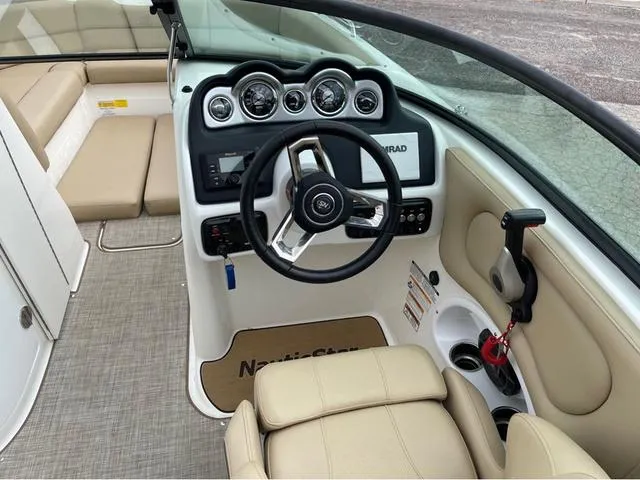 Slide: The Image of 2020 NauticStar 243 DC boat cockpit with steering wheel and dashboard. - 8