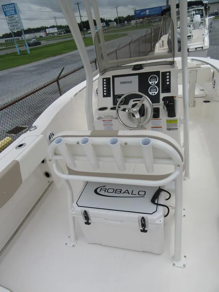 Slide: The Image of 2025 Robalo R200 Center Console boat interior with steering wheel and control panel. - 15