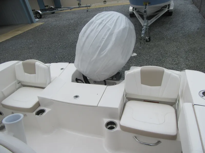 Slide: The Image of 2025 Robalo R200 Center Console boat interior with covered engine and seating area. - 17