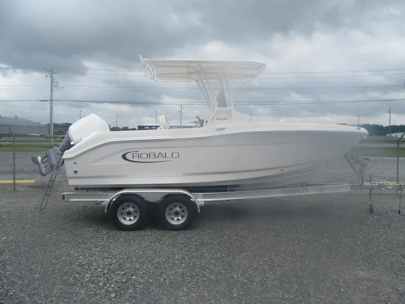 The Image of 2025 Robalo R200 Center Console boat on trailer, cloudy sky background. - 2