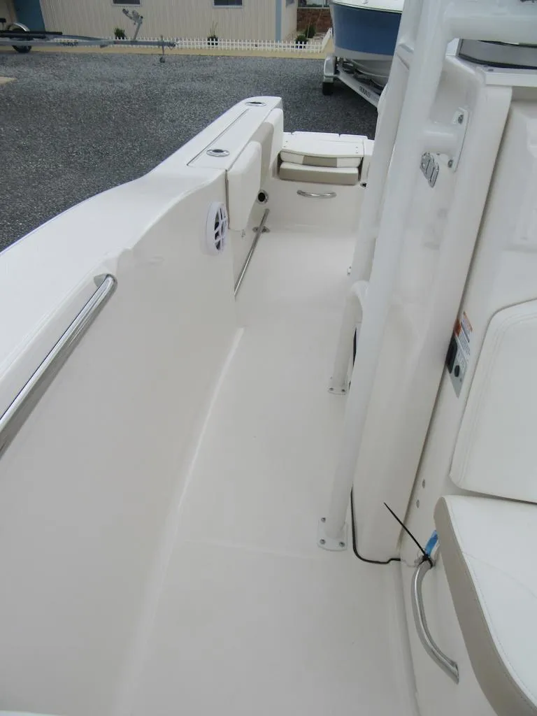 Slide: The Image of 2025 Robalo R200 Center Console boat interior, featuring sleek white design and modern amenities. - 9