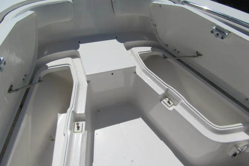 Slide: The Image of 2025 Robalo R200 Center Console boat interior with open storage compartments. - 11