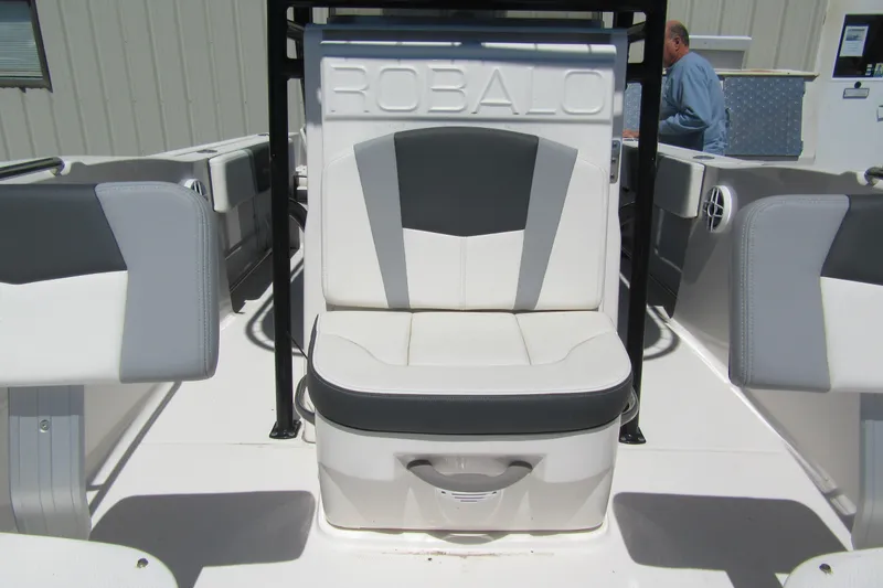 Slide: The Image of 2025 Robalo R200 Center Console boat interior with cushioned seating and modern design. - 12
