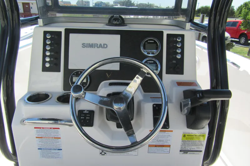 Slide: The Image of 2025 Robalo R200 Center Console dashboard with steering wheel and Simrad display. - 4