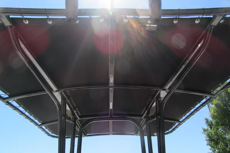 Slide: The Image of 2025 Robalo R200 Center Console T-top with sun rays shining through. - 5