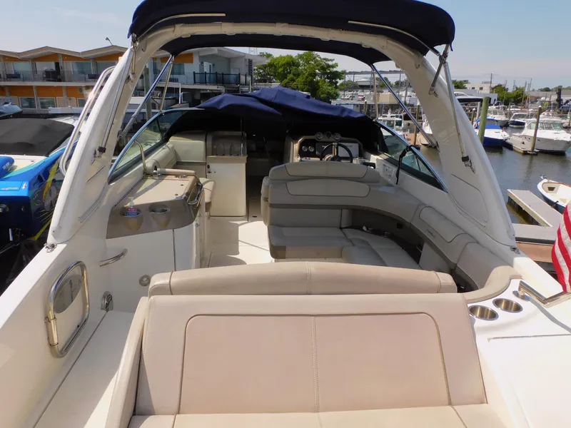 Slide: The Image of 2015 Formula Bowrider 290 interior with seating and helm, docked at marina. - 15