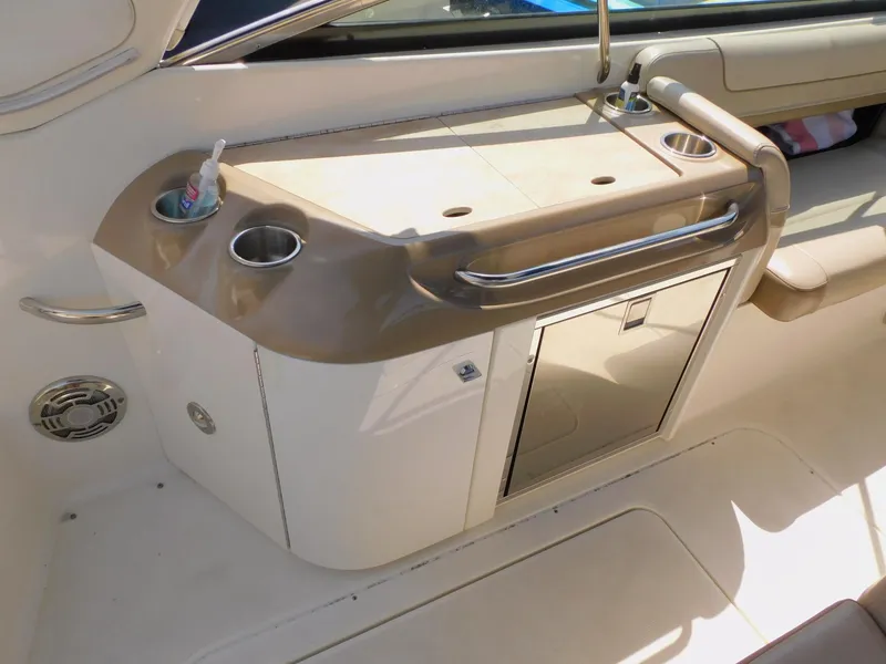Slide: The Image of 2015 Formula Bowrider 290 interior with sink, cup holders, and storage cabinet. - 23