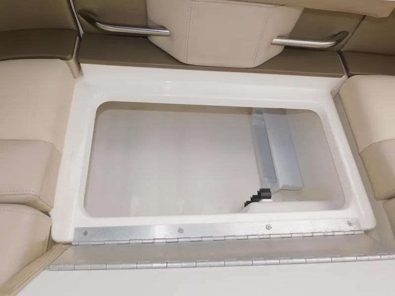 Slide: The Image of 2015 Formula Bowrider 290 storage compartment with beige seating and metal handles. - 31