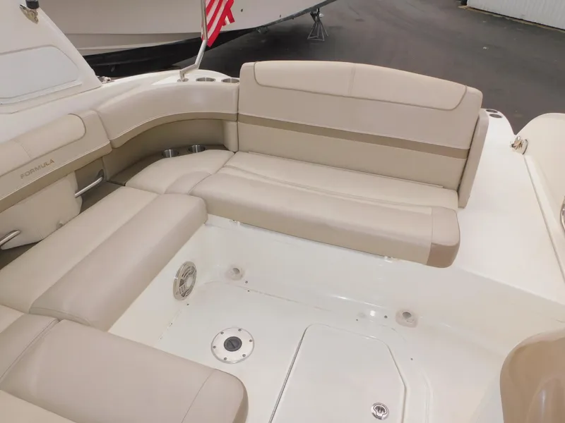 Slide: The Image of 2015 Formula Bowrider 290 interior with beige seating and American flag. - 32