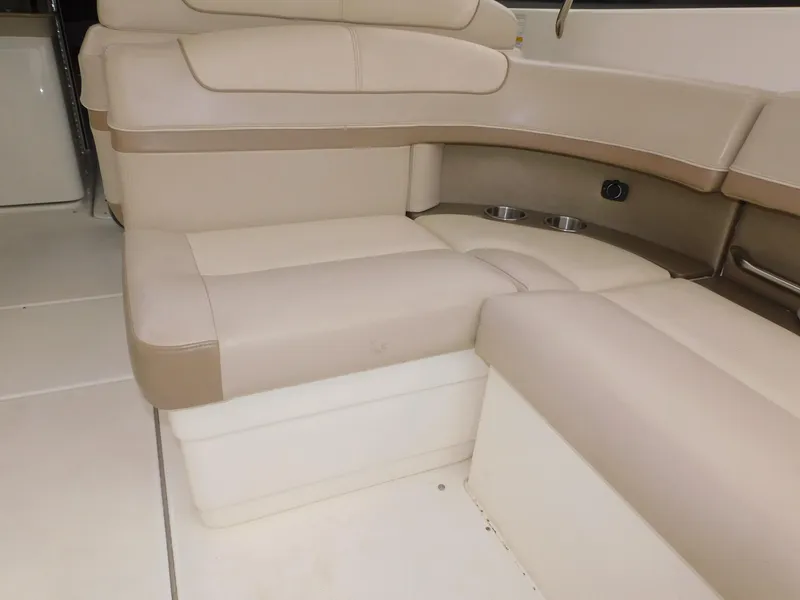 Slide: The Image of 2015 Formula Bowrider 290 interior seating with beige upholstery and cup holders. - 33