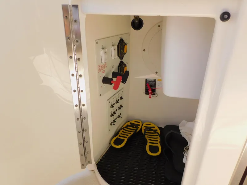 Slide: The Image of 2015 Formula Bowrider 290 interior compartment with control panel and shoes. - 35