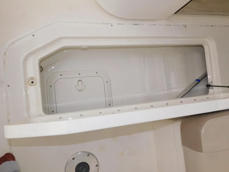 Slide: The Image of Storage compartment on a 2015 Formula Bowrider 290 boat, featuring a white interior. - 37