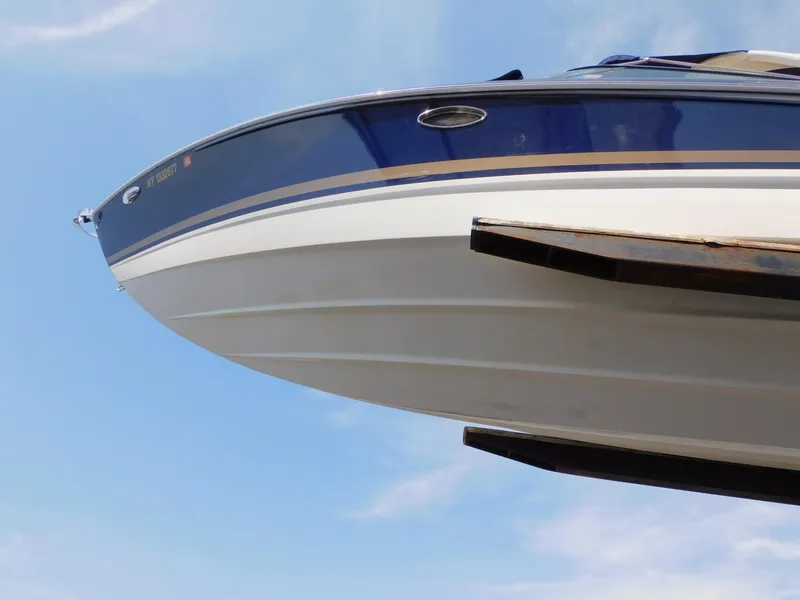 Slide: The Image of 2015 Formula Bowrider 290 boat on lift against blue sky background. - 4
