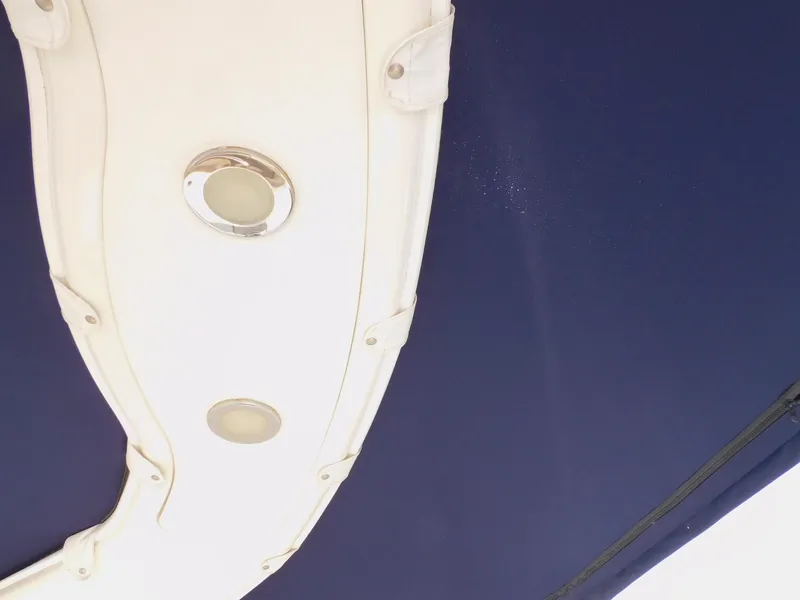 Slide: The Image of 2015 Formula Bowrider 290 boat interior ceiling with lights and blue canopy. - 41