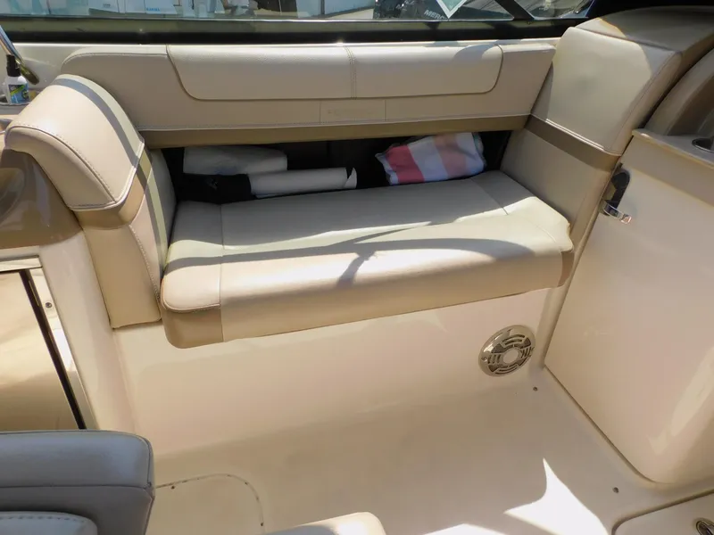 Slide: The Image of 2015 Formula Bowrider 290 interior with beige seating and storage compartment. - 42