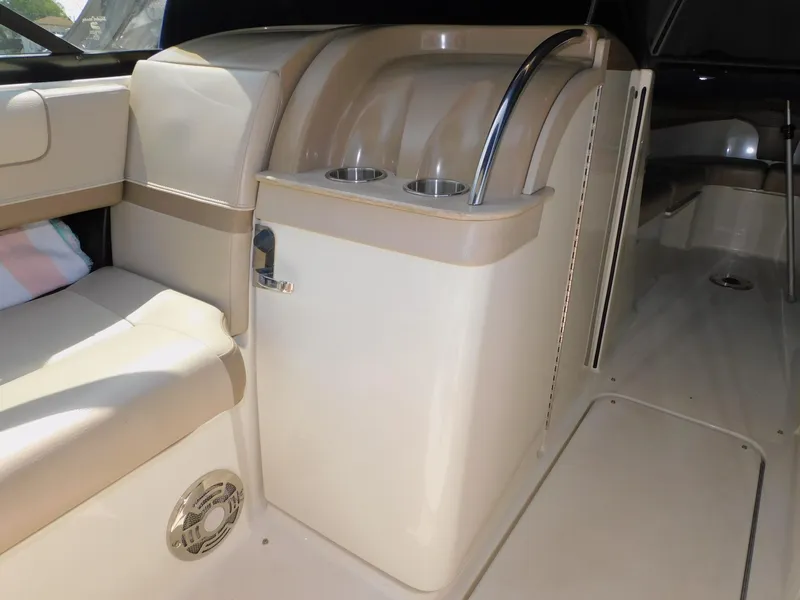 Slide: The Image of Interior of 2015 Formula Bowrider 290, featuring beige seating and cup holders. - 44