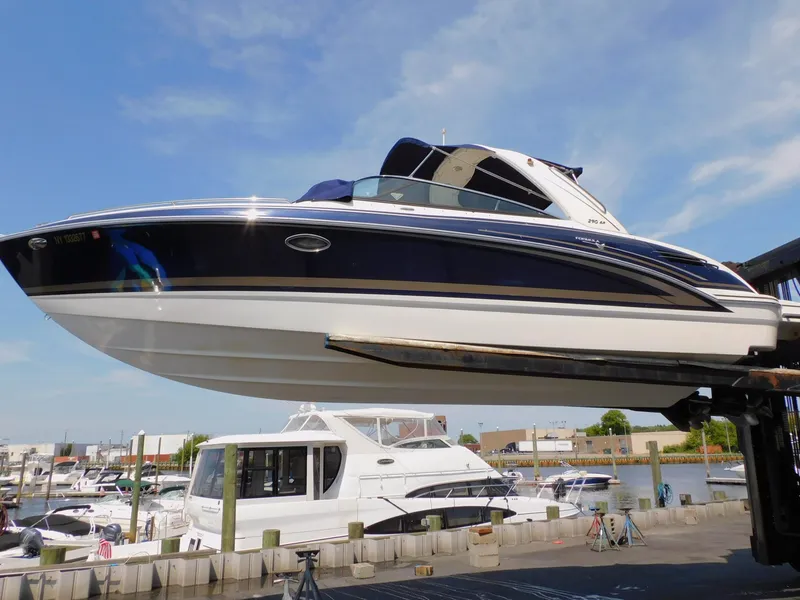 Slide: The Image of 2015 Formula Bowrider 290 boat lifted at marina, clear sky background. - 5