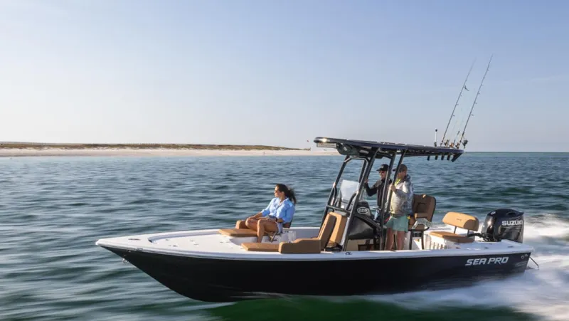 Slide: The Image of 2024 Sea Pro 230 Bay boat cruising on open water with passengers. - 1