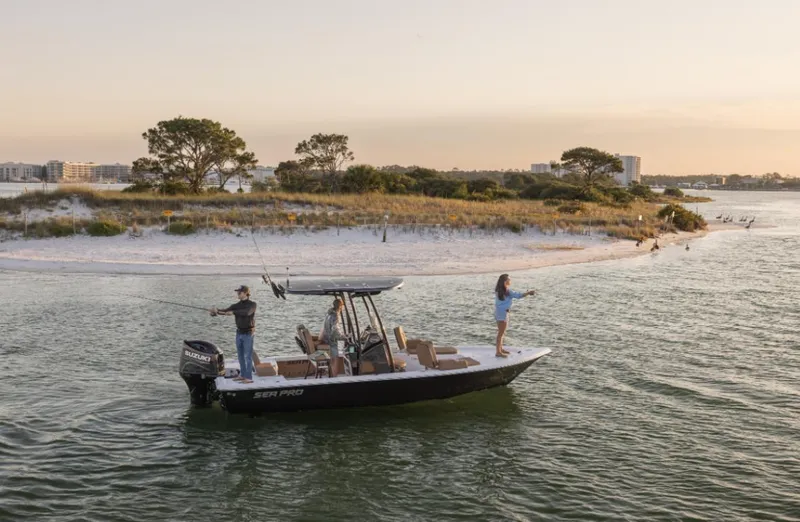 Slide: The Image of 2024 Sea Pro 230 Bay boat fishing near a scenic shoreline at sunset. - 3