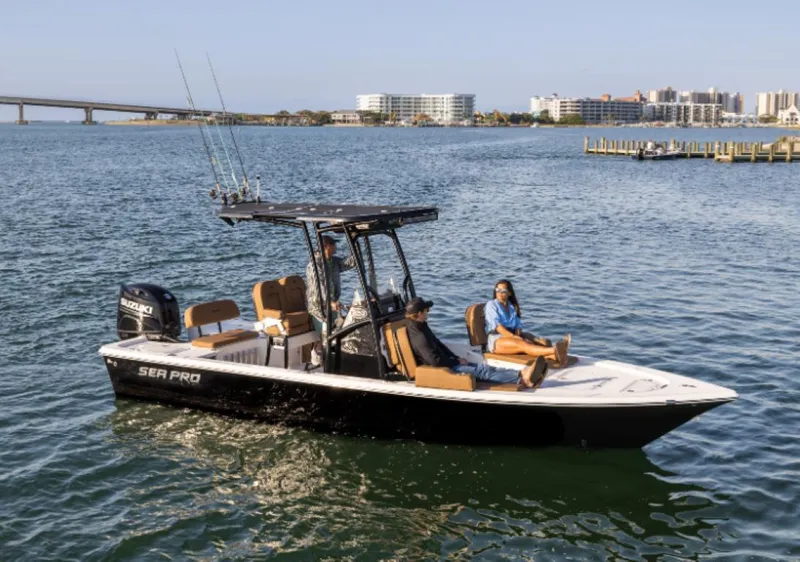 Slide: The Image of 2024 Sea Pro 230 Bay boat cruising on water with passengers relaxing. - 7