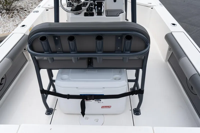 Slide: The Image of 2024 Sea Born FX24 Bay boat interior with rod holders and cooler. - 10