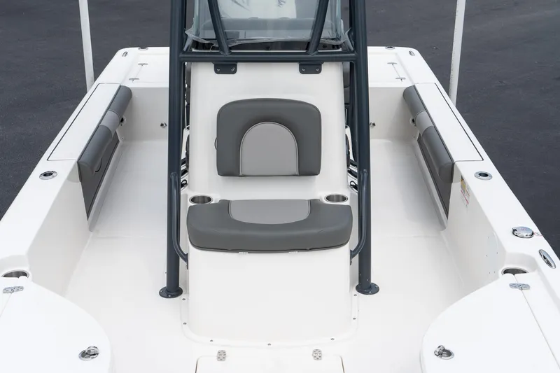 Slide: The Image of 2024 Sea Born FX24 Bay boat interior with cushioned seating and storage compartments. - 18