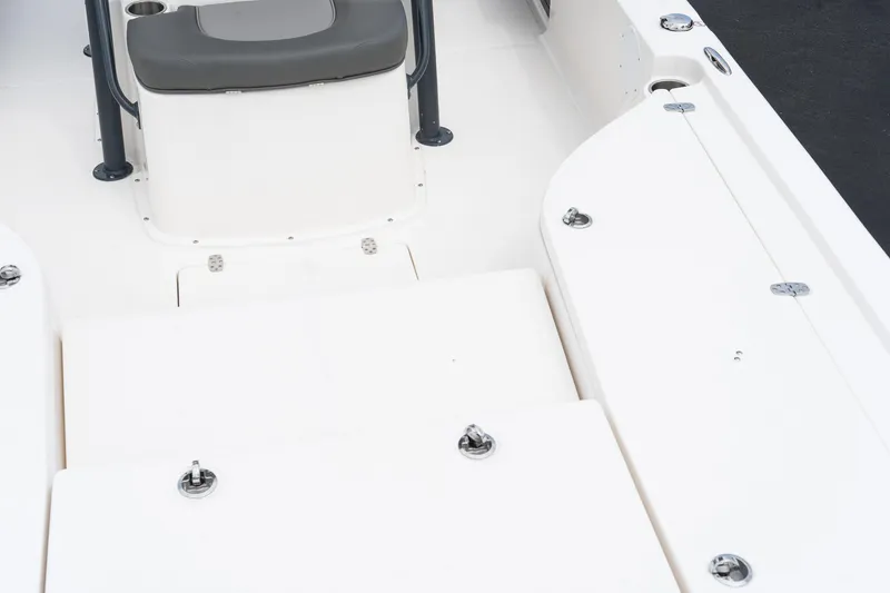 Slide: The Image of 2024 Sea Born FX24 Bay boat interior, featuring seating and storage compartments. - 19