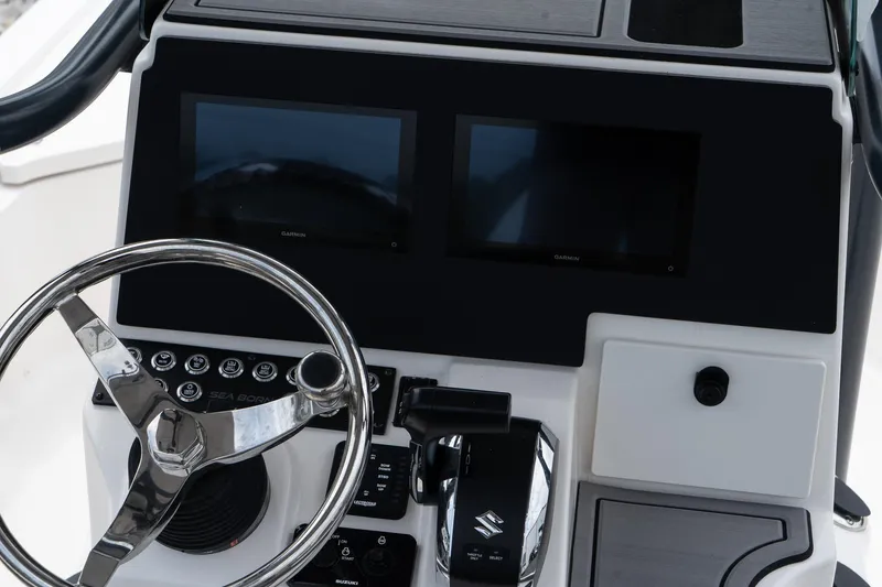 Slide: The Image of 2024 Sea Born FX24 Bay boat console with dual screens and steering wheel. - 31