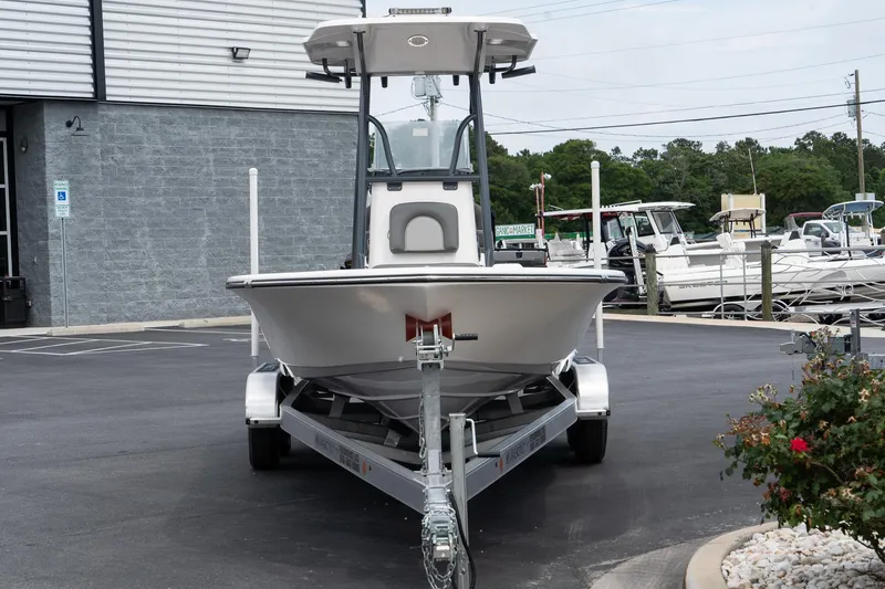 Slide: The Image of 2024 Sea Born FX24 Bay boat on a trailer in a parking lot. - 4