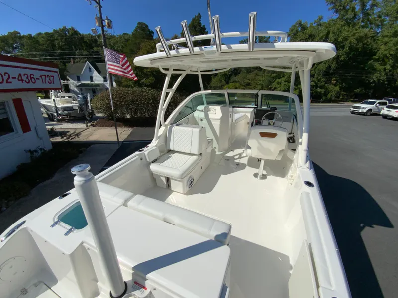 Slide: The Image of 2025 Pursuit DC 246 Dual Console boat with spacious seating and modern design. - 10