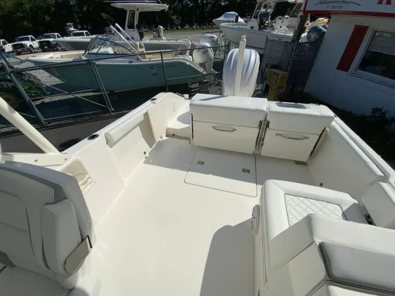 Slide: The Image of 2025 Pursuit DC 246 Dual Console boat interior, spacious seating, and modern design. - 15