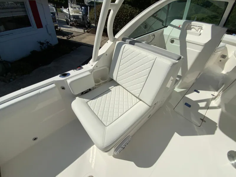 Slide: The Image of 2025 Pursuit DC 246 Dual Console boat with white leather seating. - 16