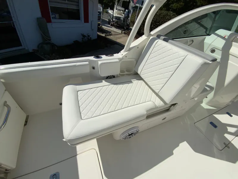 Slide: The Image of 2025 Pursuit DC 246 Dual Console boat with white cushioned seating. - 17