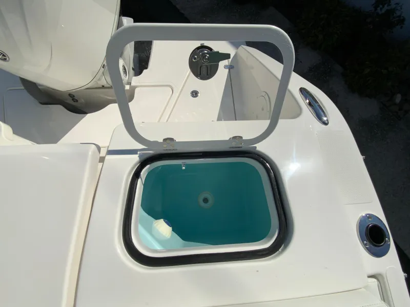 Slide: The Image of 2025 Pursuit DC 246 Dual Console boat with open livewell on deck. - 19