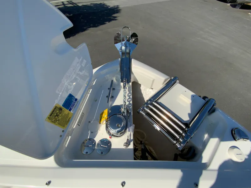 Slide: The Image of 2025 Pursuit DC 246 Dual Console boat anchor and ladder detail. - 23