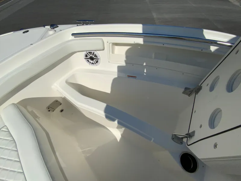 Slide: The Image of Interior of 2025 Pursuit DC 246 Dual Console boat, featuring seating and storage. - 25