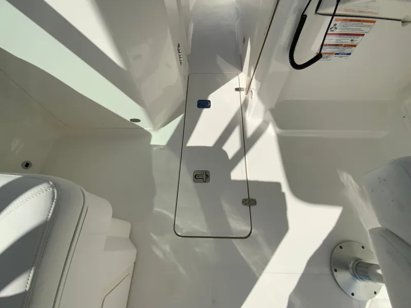 Slide: The Image of 2025 Pursuit DC 246 Dual Console interior, featuring sleek white design and modern fittings. - 26